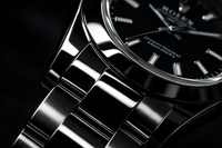 show high mirror shined rolex style watch, zoom into a part which is extremely shiny